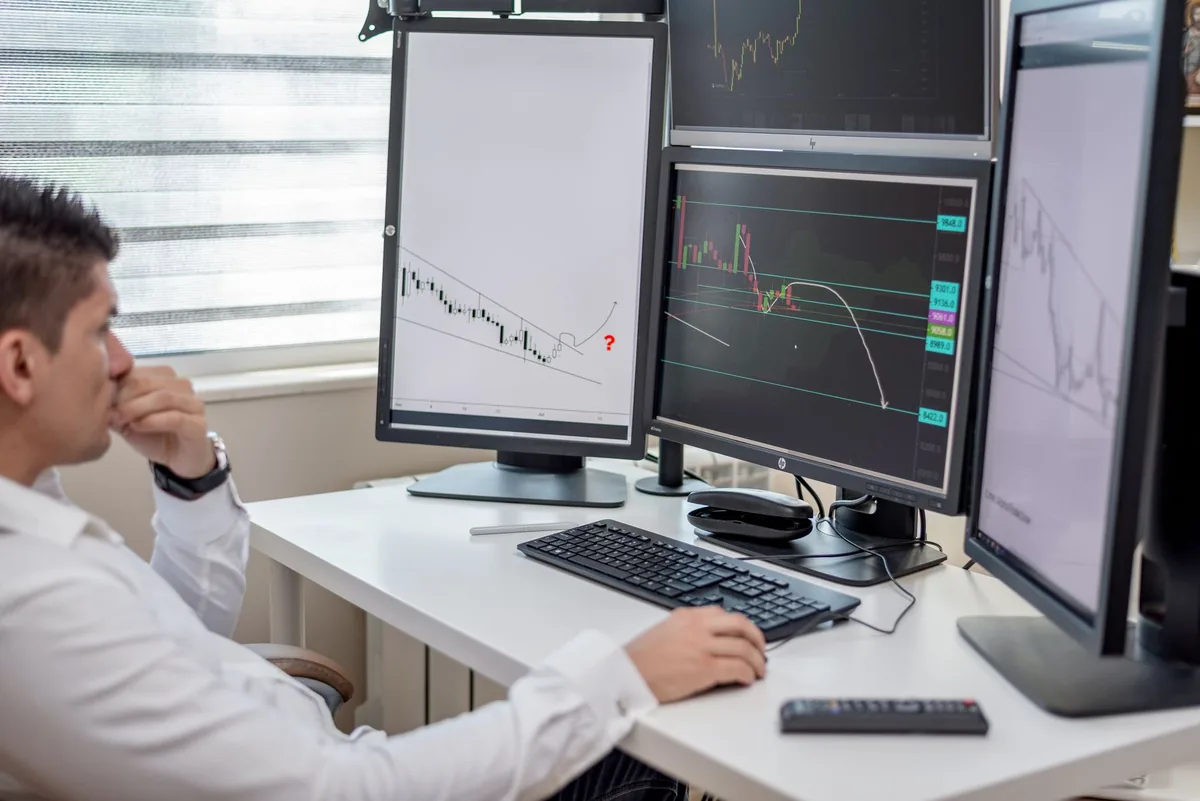 financial analyst looking at computer dashboard