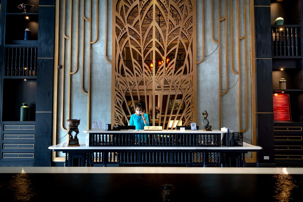 modern luxury hotel lobby lounge with guest using smartphone