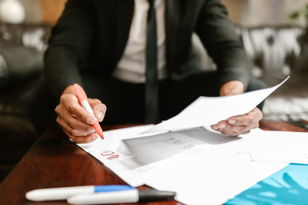 hotel manager reviewing paperwork lobby desk