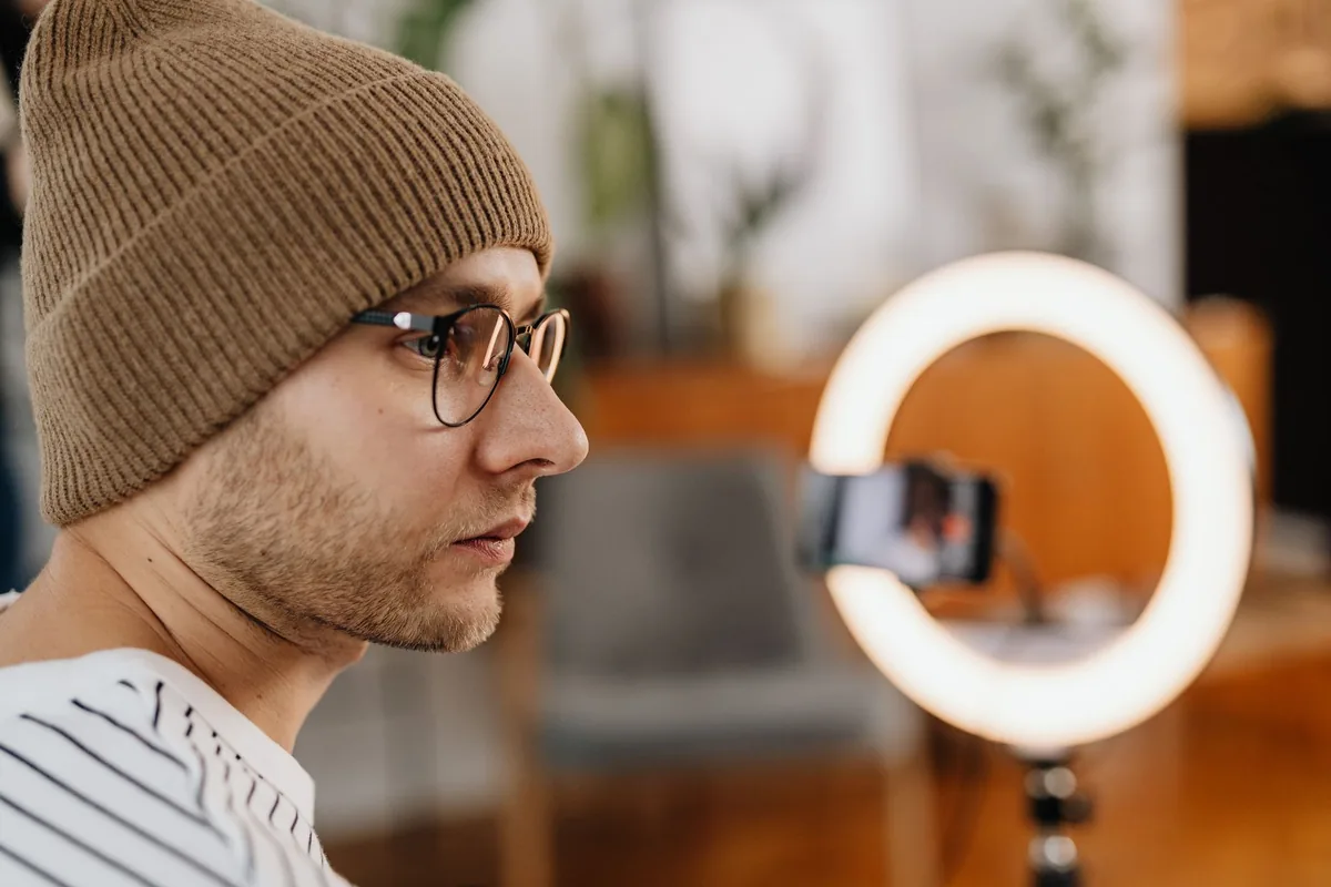 content creator recording smartphone video hotel room