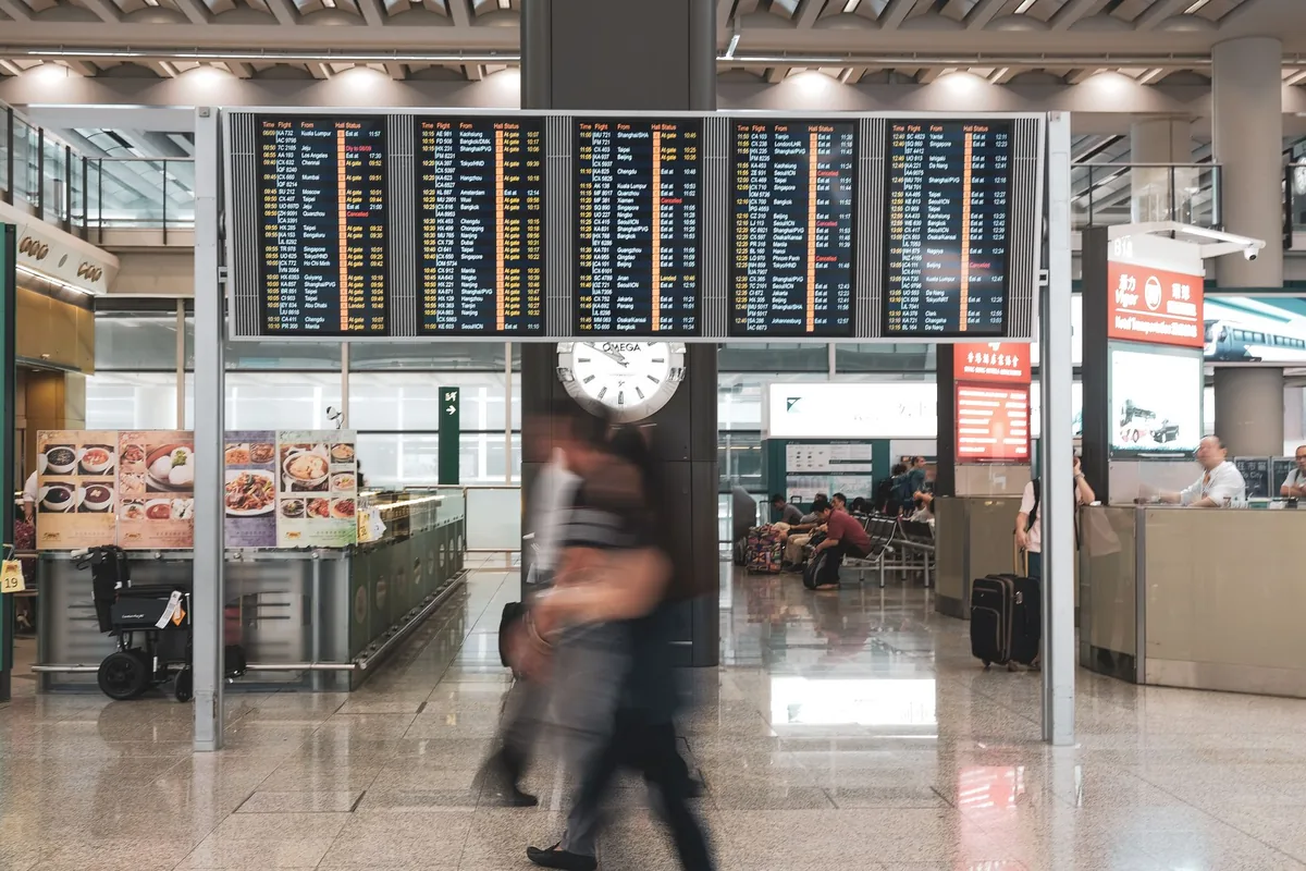 airport departure board showing flight cancellations
