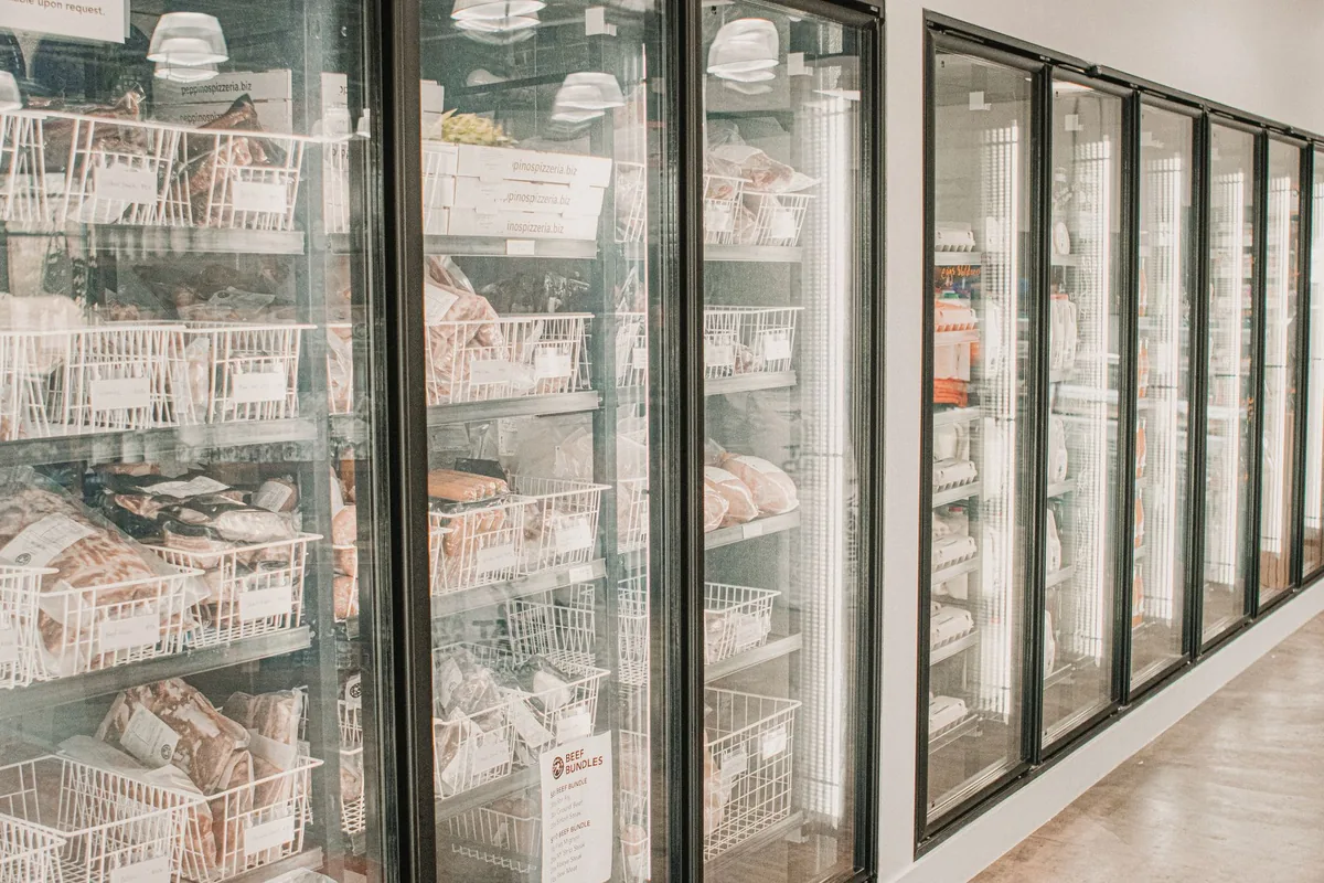 raw meat and fish stored in commercial walk in refrigerator
