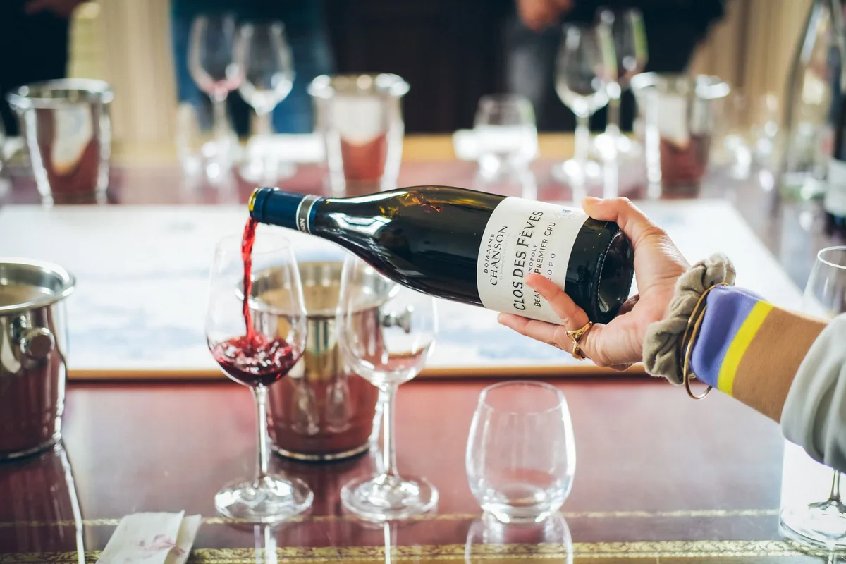 sommelier pouring wine fine dining restaurant