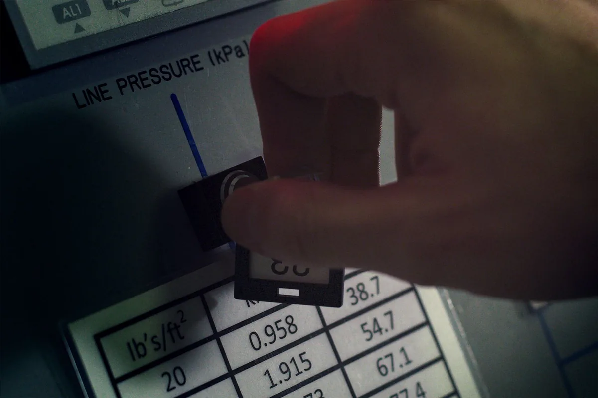 hotel operations manager checking mechanical room gauges