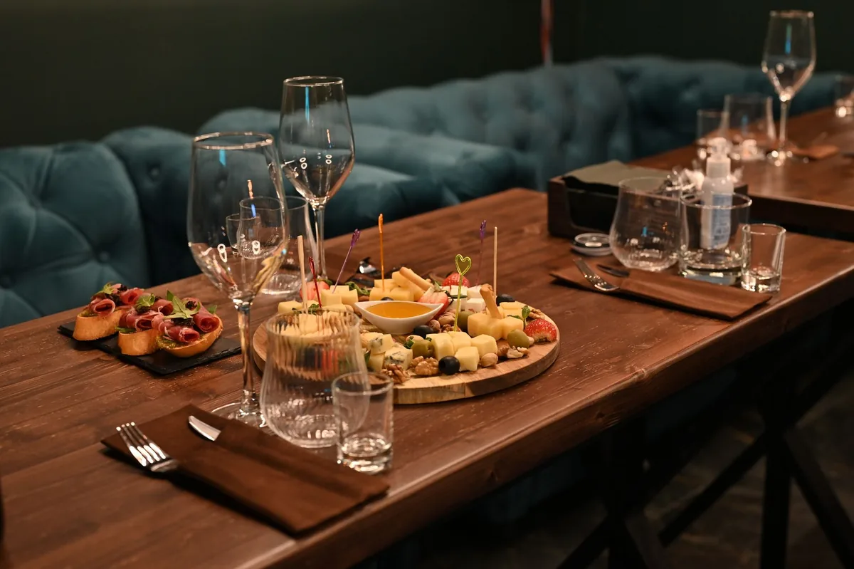 French Riviera inspired table setting with wine goblets and serving trays