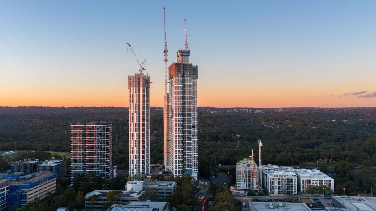 construction site of a new high-rise hotel with cranes visible