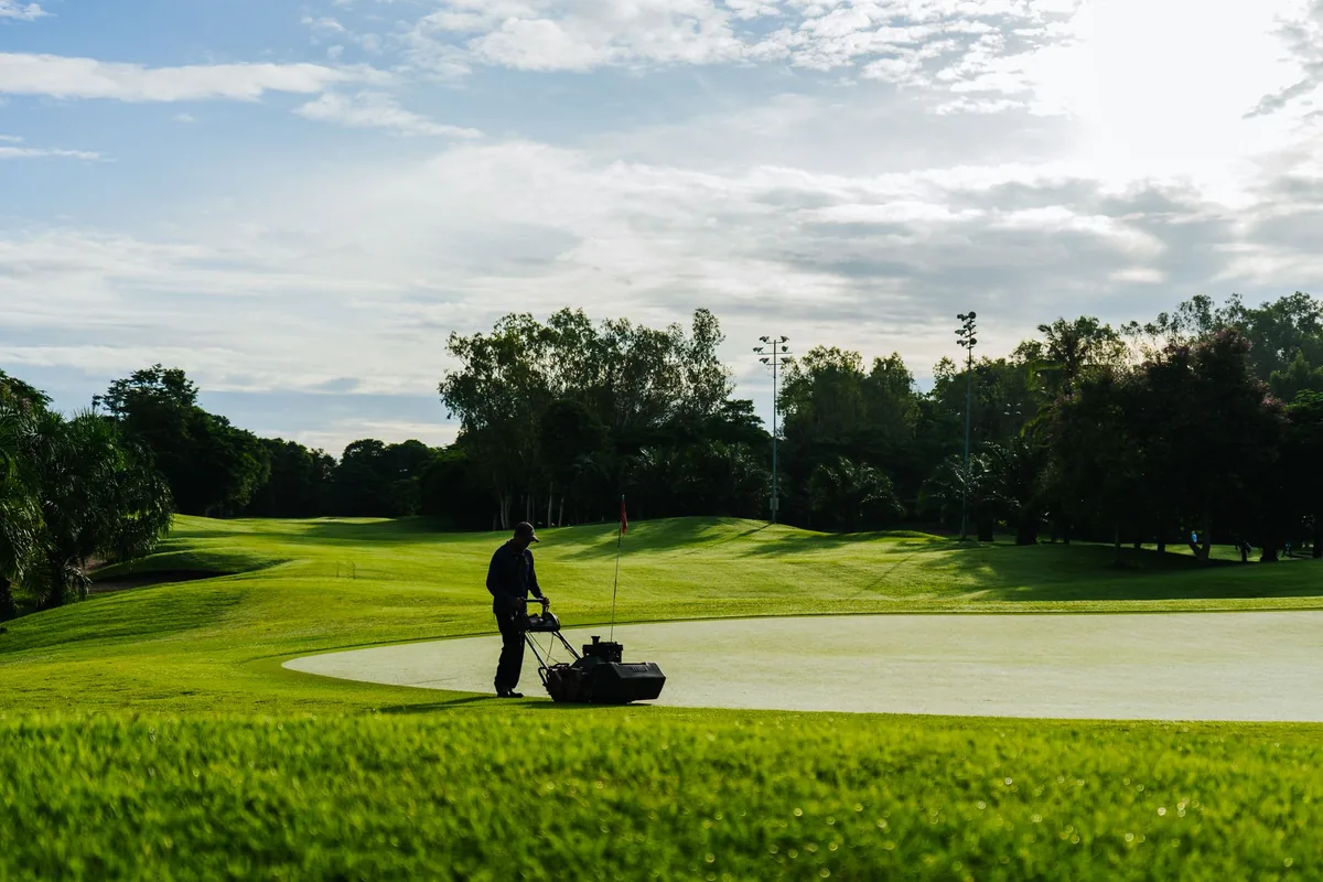 resort golf course groundskeeper maintaining green