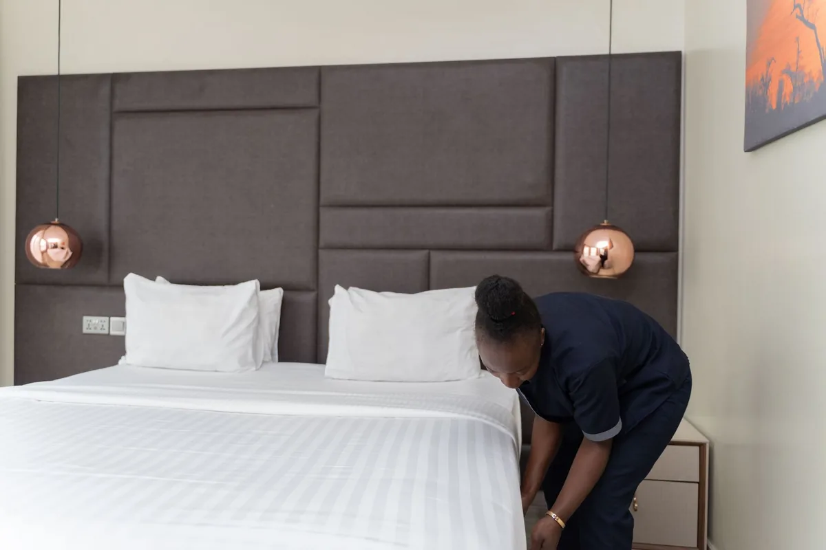 clean guest room bed in select service hotel