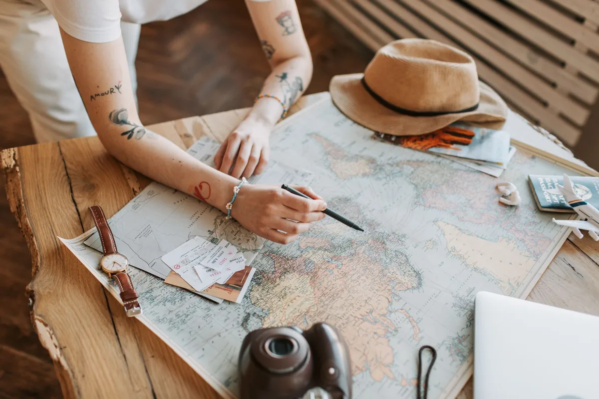 traveler using laptop cafe map