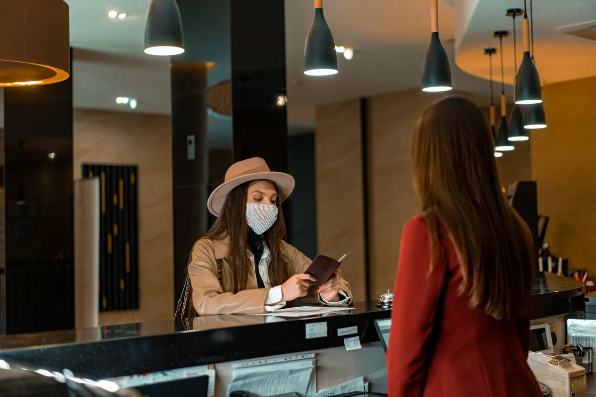 hotel guest using a smartphone in a modern lobby