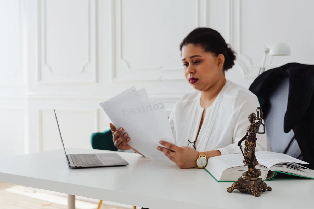lawyer reading legal documents at a desk