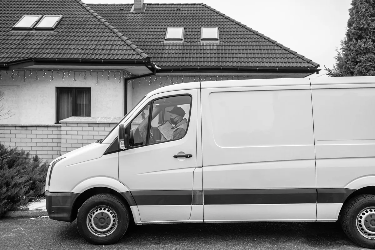 tiny home on wheels parked in a residential driveway