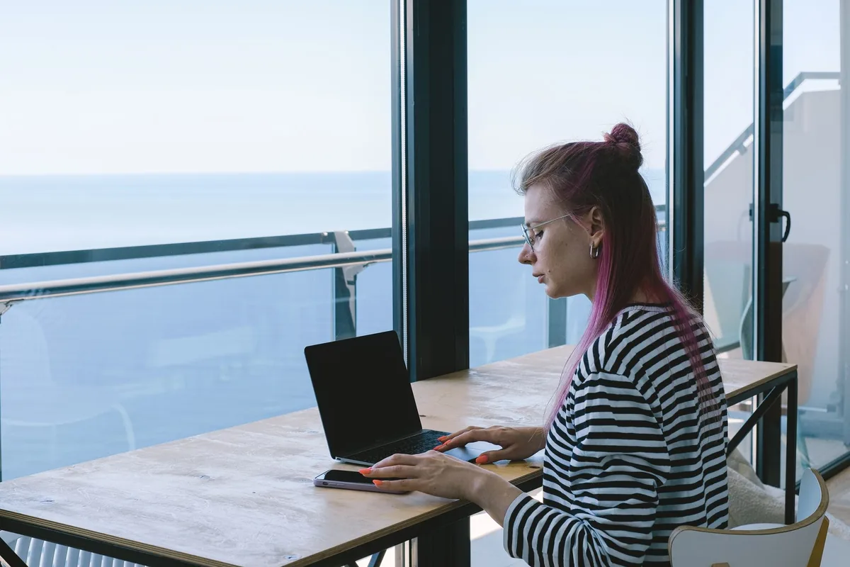 business traveler working on a laptop at a hotel desk