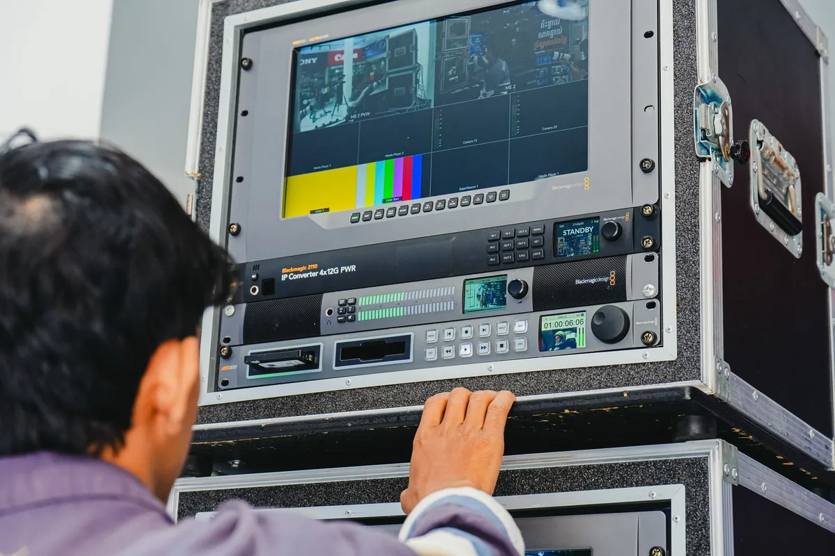hotel technician configuring television screen