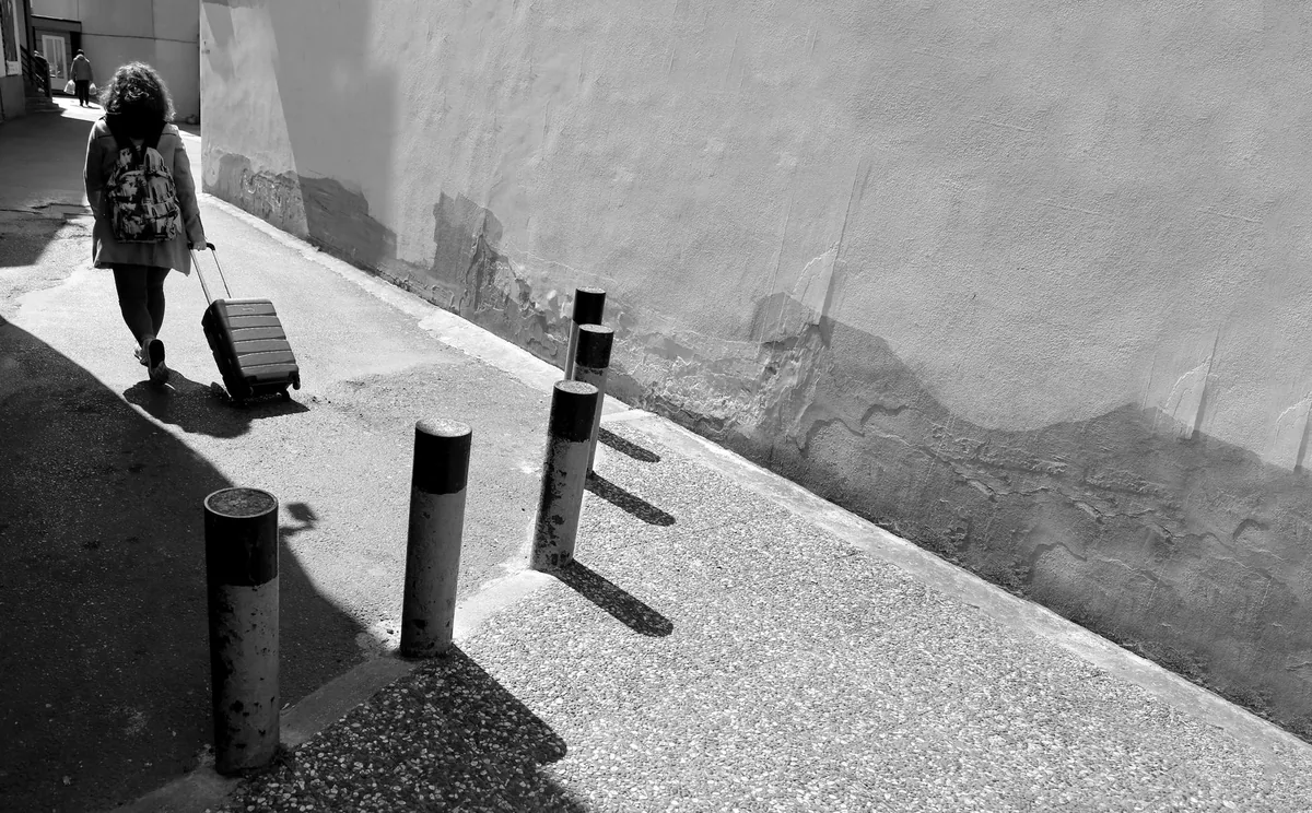 tourist family luggage city sidewalk