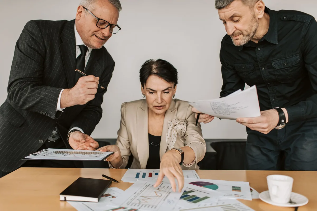 financial analysts reviewing charts boardroom