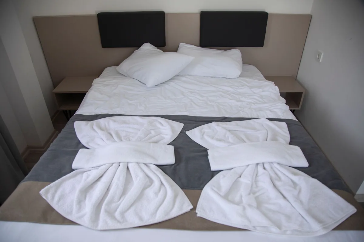 hotel room interior with neatly made bed