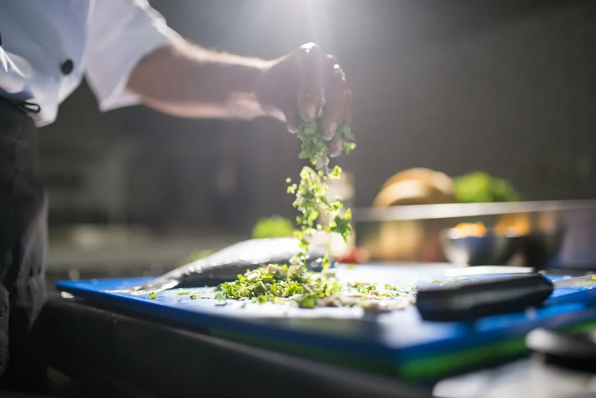 chef chopping vegetables restaurant kitchen