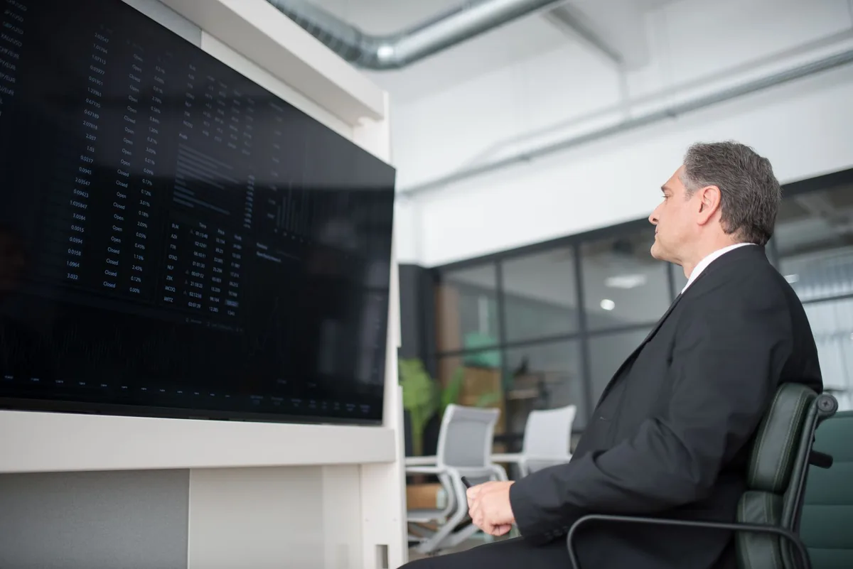 hotel general manager examining digital analytics screen