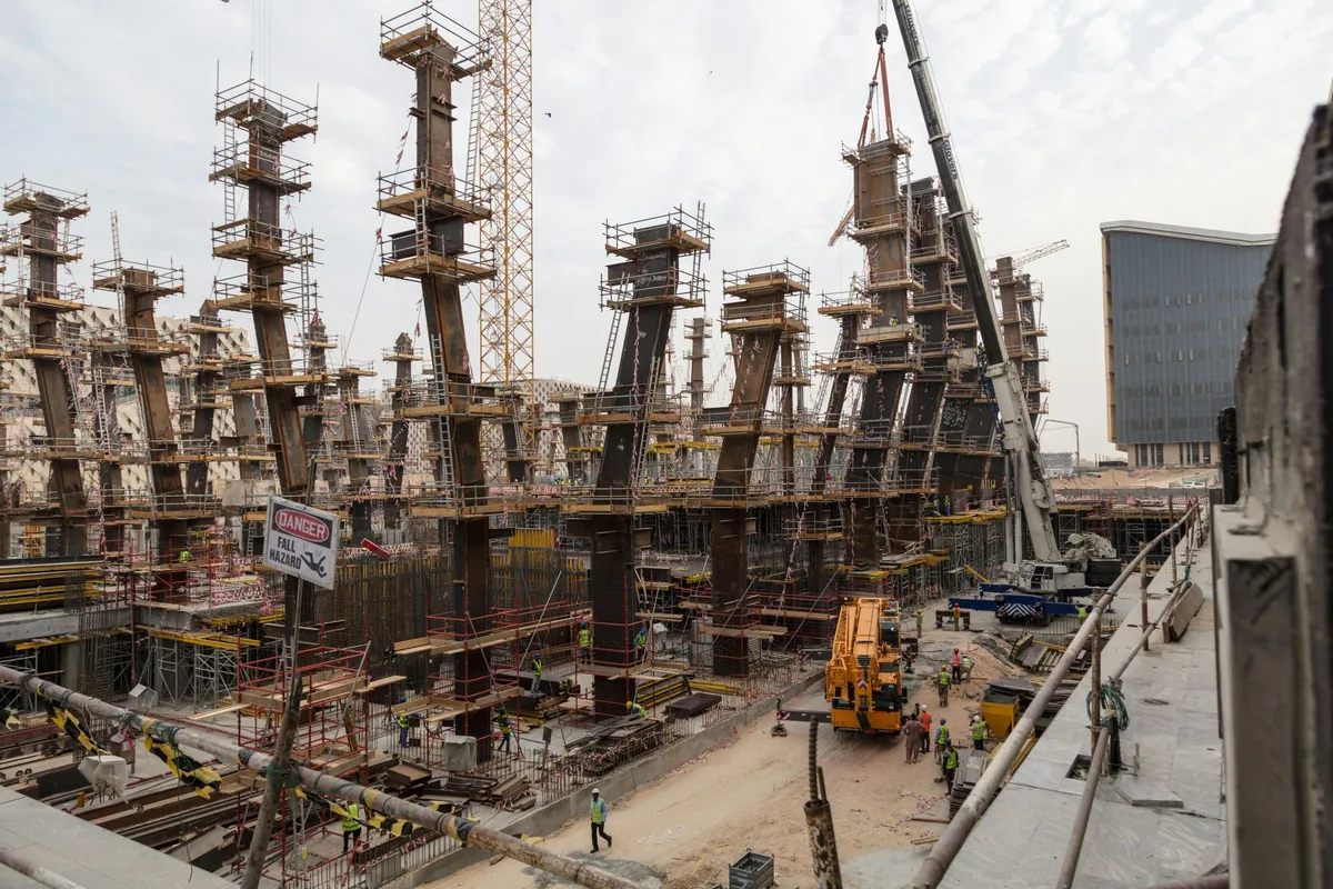 construction site with cranes and workers