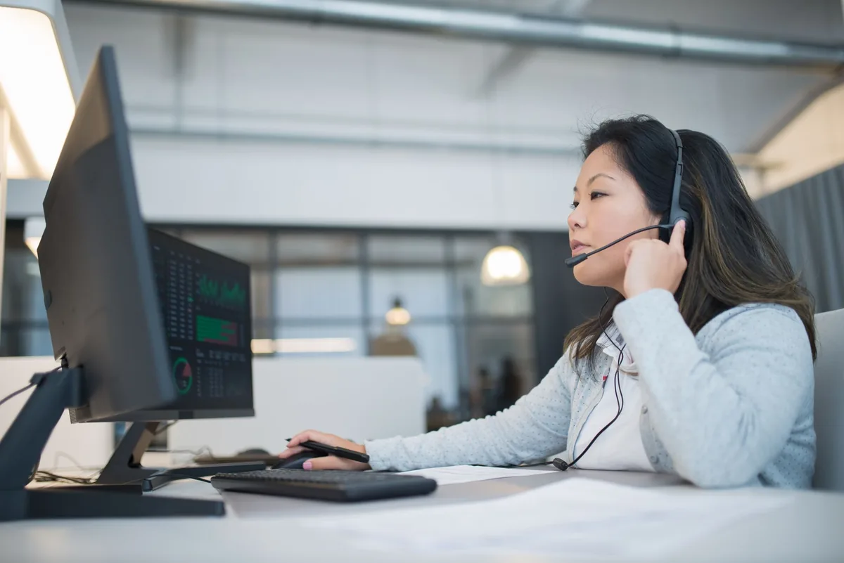 corporate travel agent working at computer desk