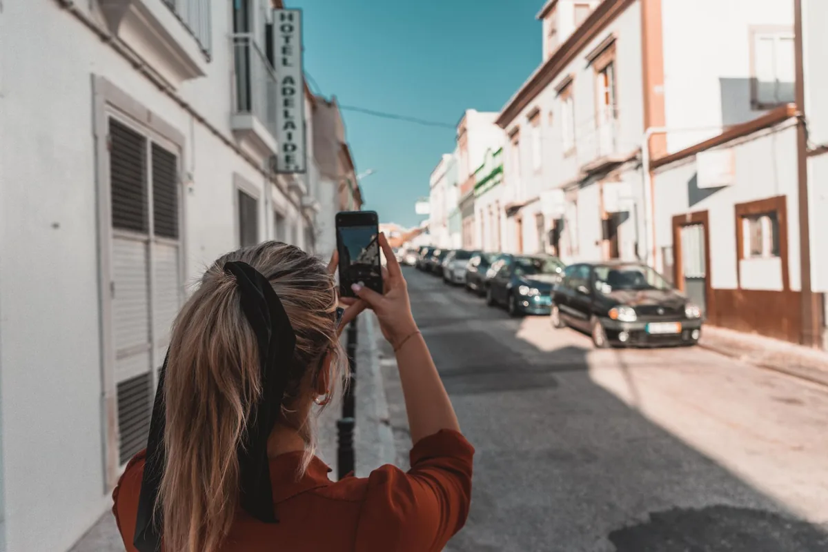 young woman taking photo hotel restaurant breakfast