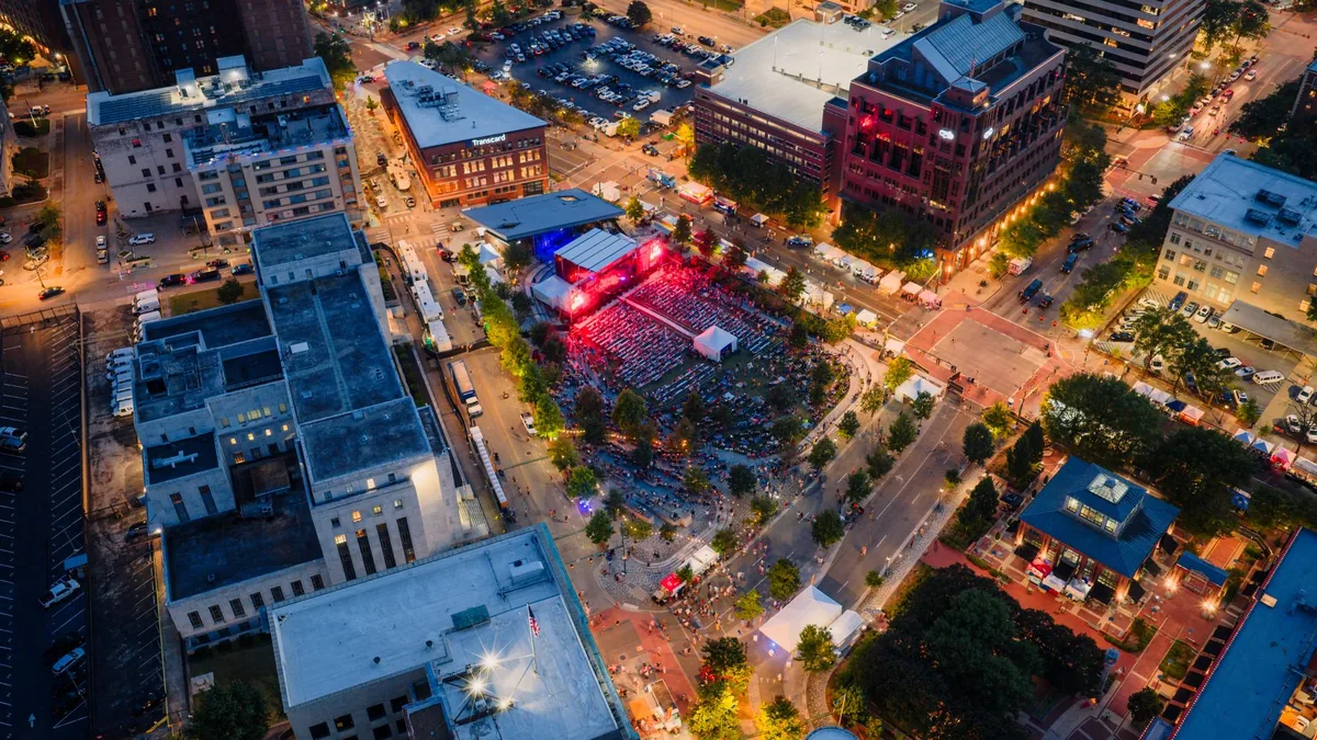 crowd enjoying evening rooftop event at a downtown hotel