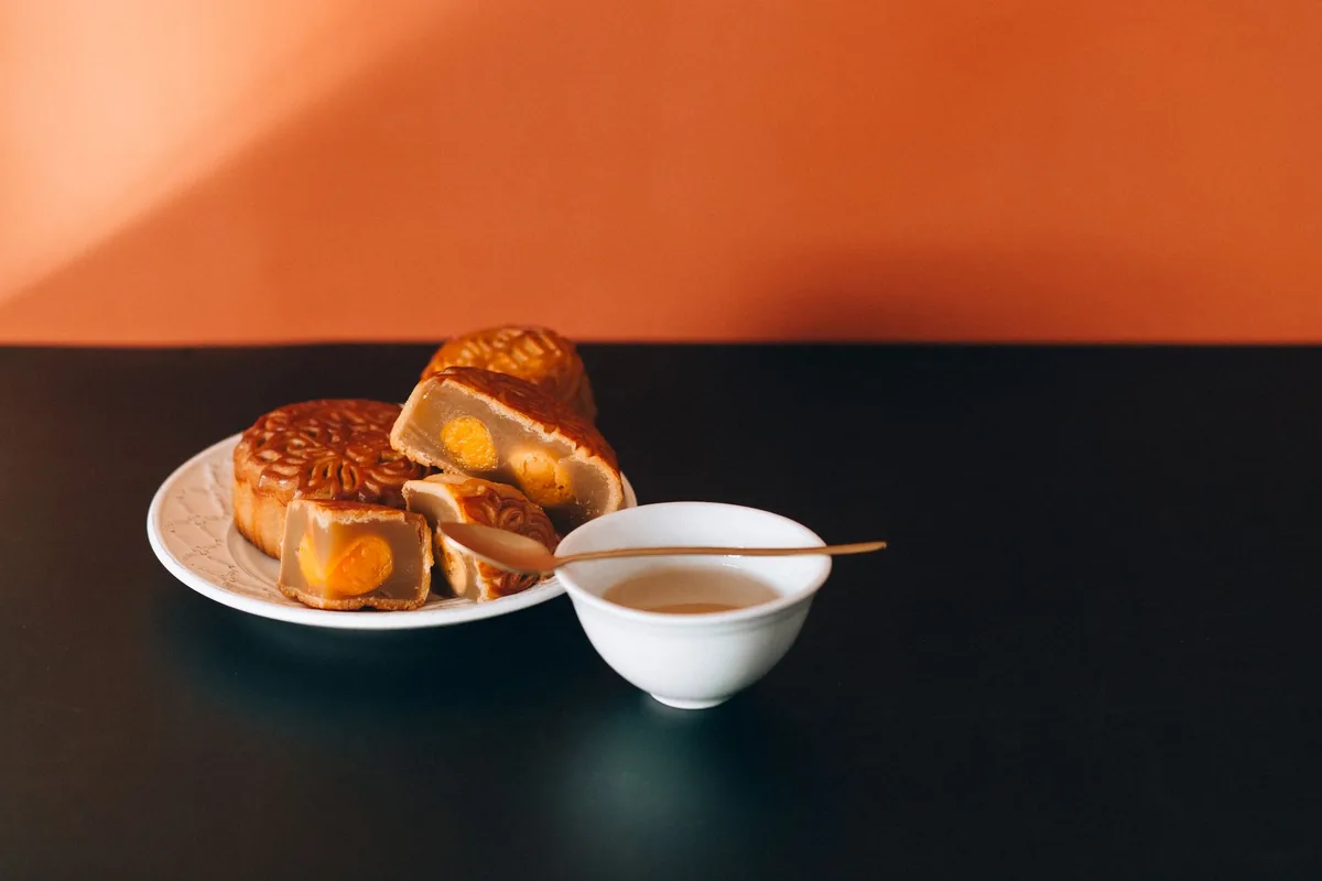 close up of sliced mooncake showing egg yolk