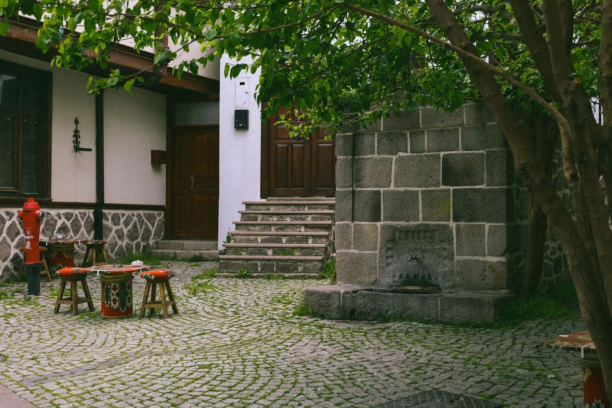 outdoor hotel courtyard with a stone fireplace and seating area