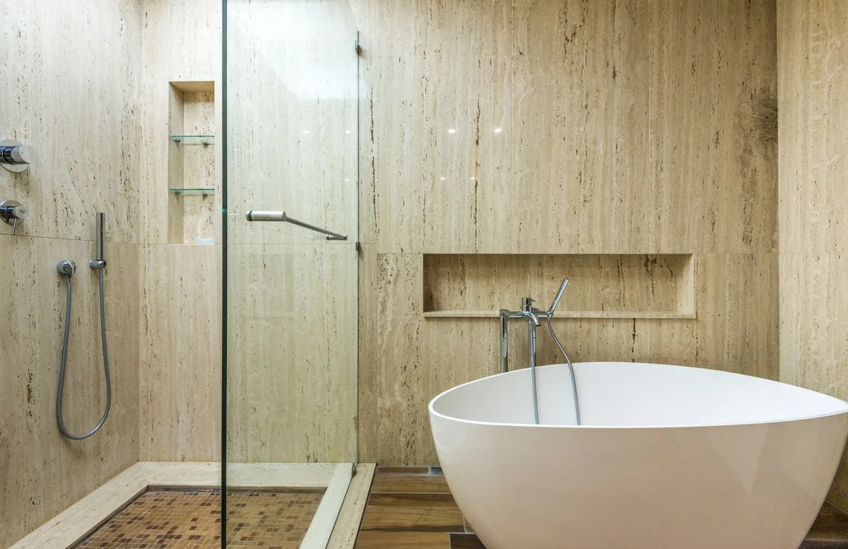 hotel bathroom glass walk-in shower travertine tile