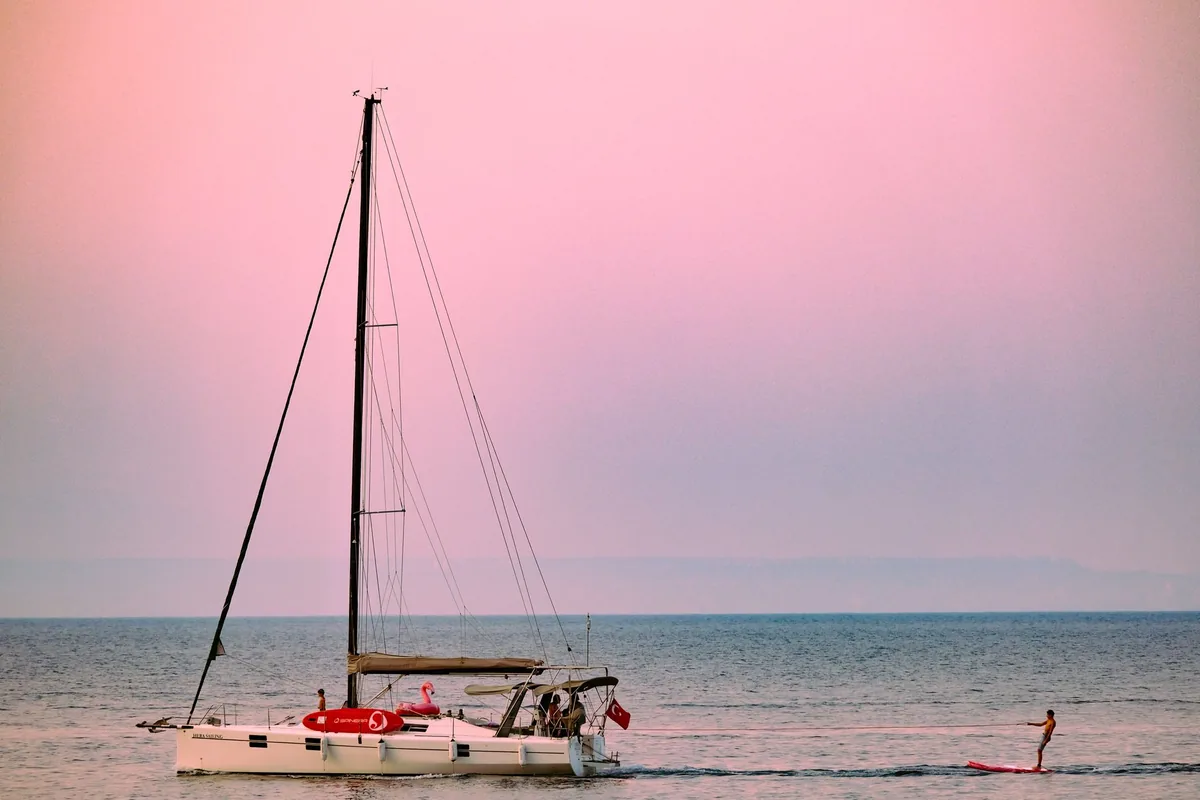 catamaran sailing at sunset