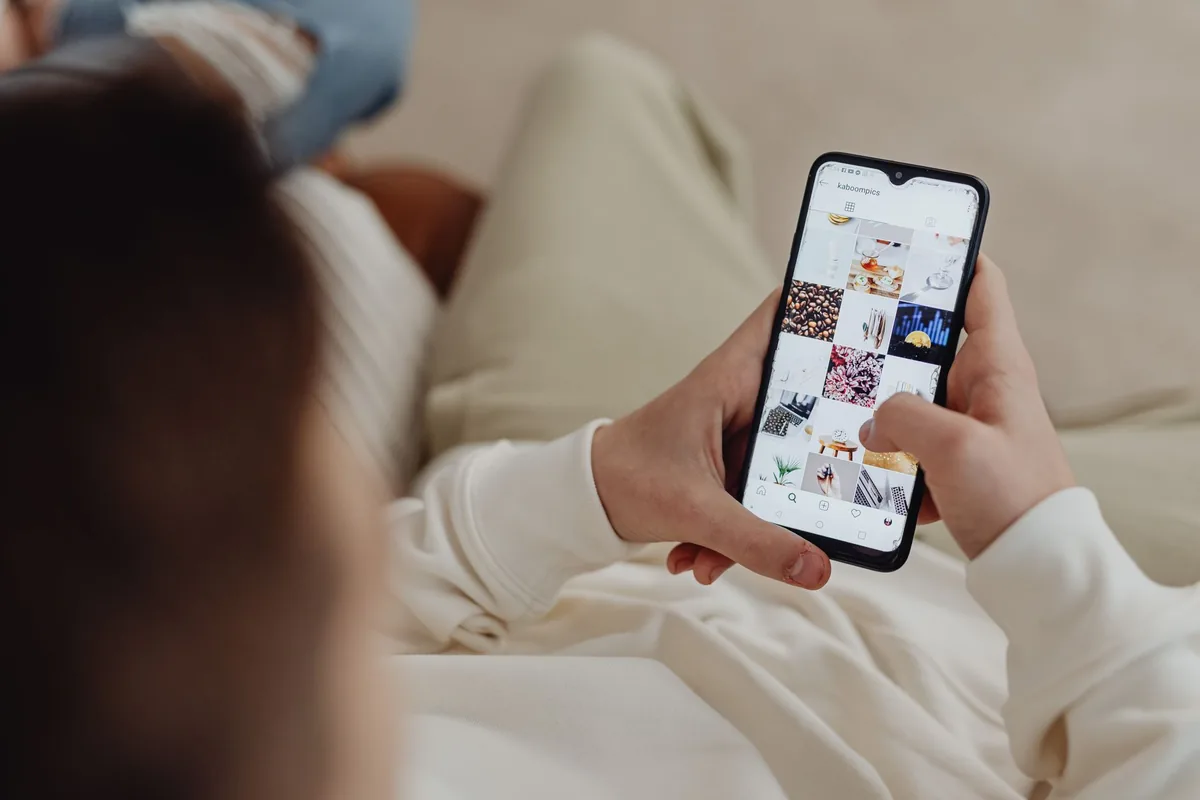 person scrolling travel photos on a smartphone