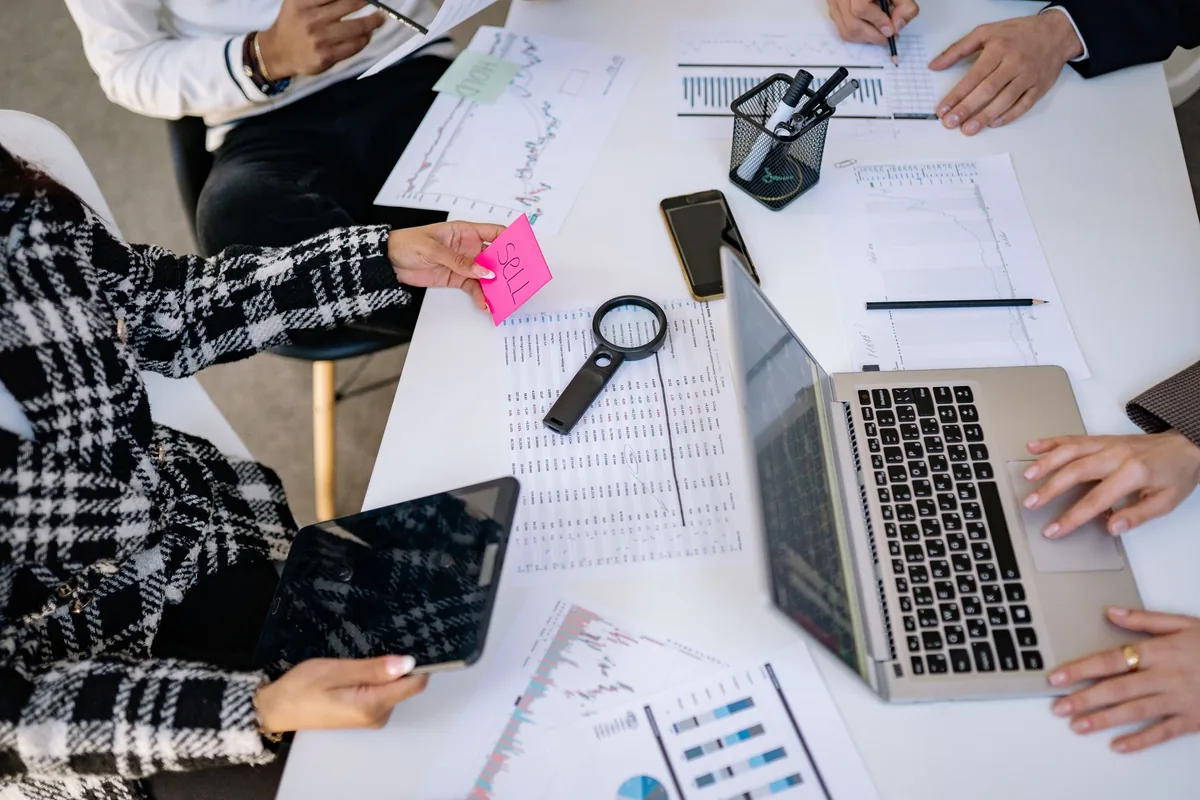 marketing team reviewing charts on a laptop