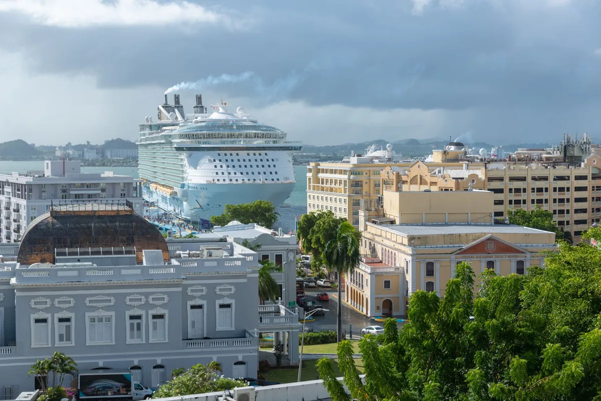 large cruise ship docked at a modern caribbean port facility