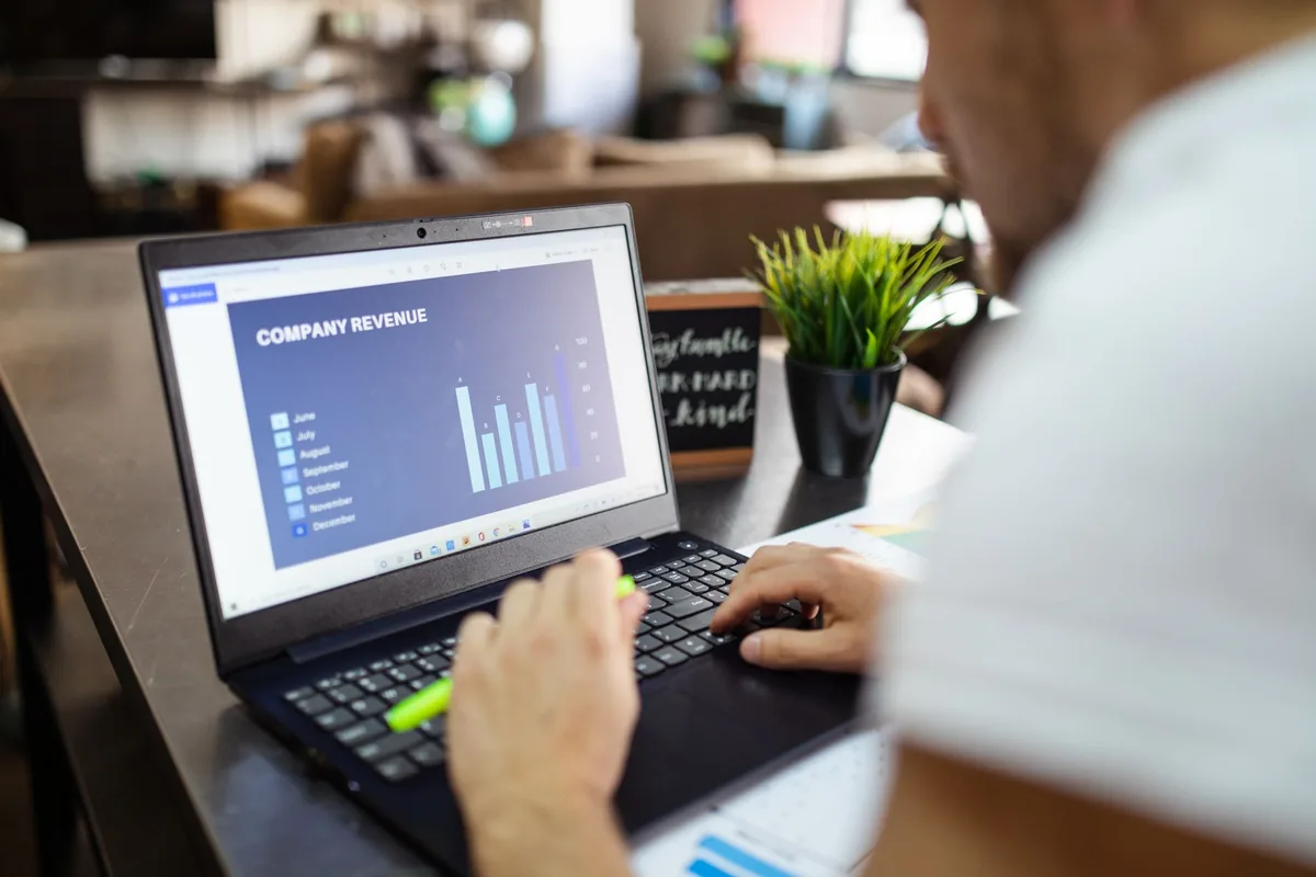 revenue manager working on laptop with charts and numbers