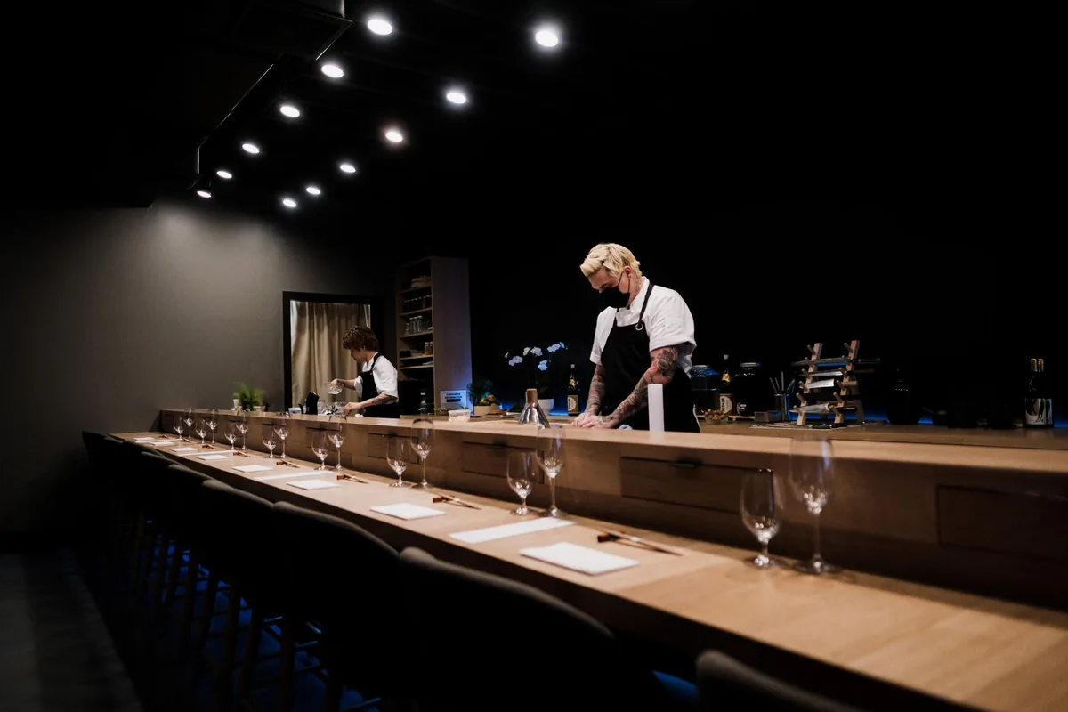intimate wooden sushi counter with soft ambient lighting