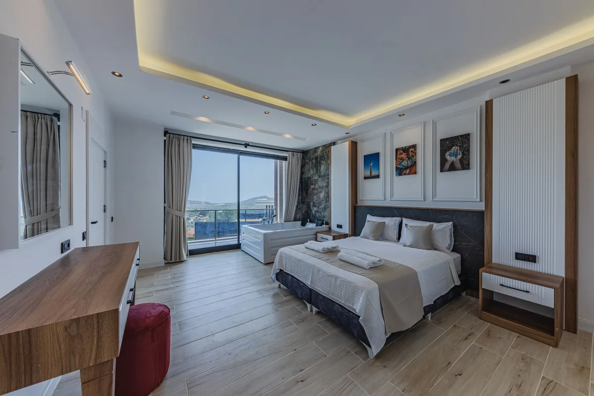 modern hotel room with fully equipped kitchen and balcony overlooking water