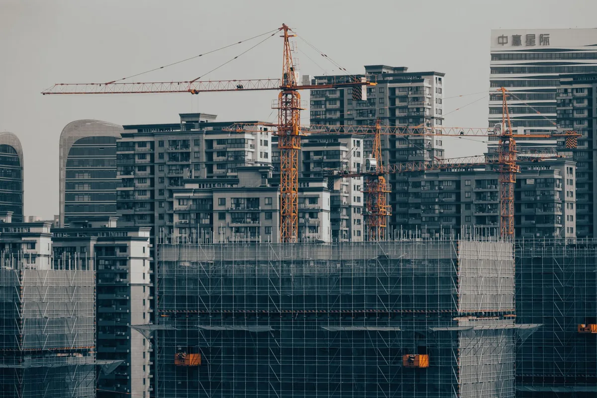 hotel construction site with scaffolding and cranes