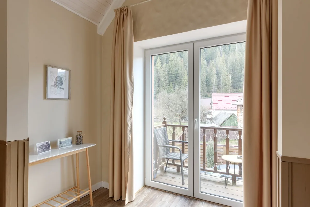 modern alpine hotel suite glass balcony mountain view