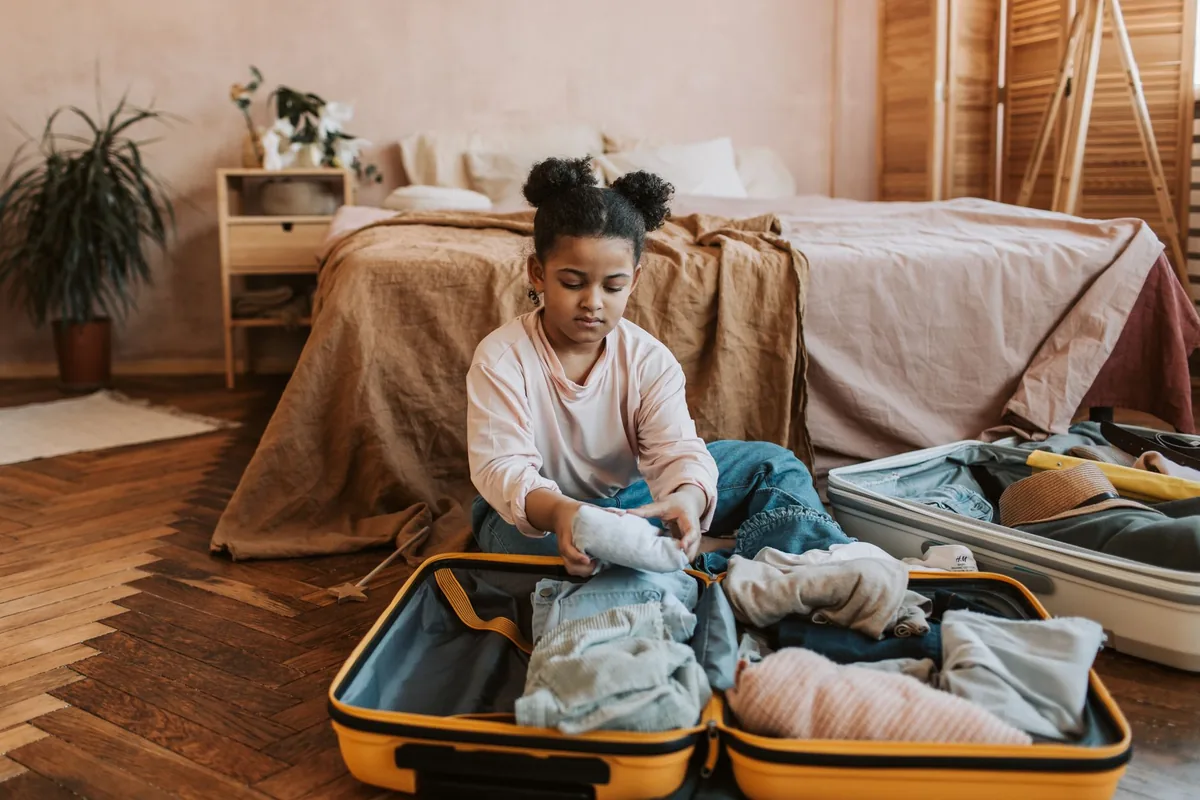 family packing luggage into vehicle