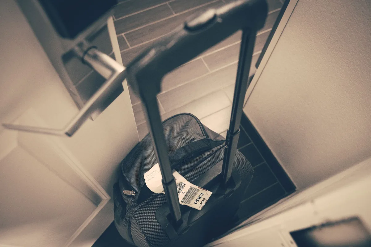 business traveler suitcase hotel room entrance