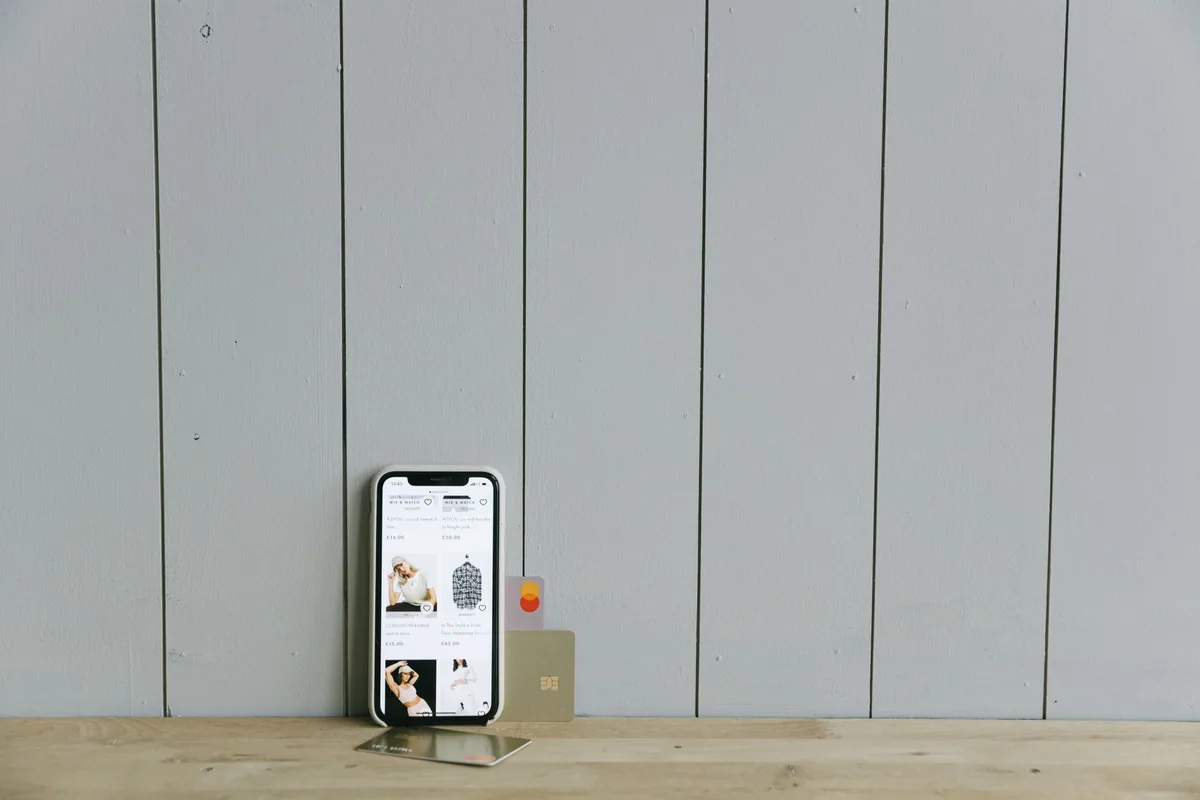 smartphone displaying a hotel booking app next to a credit card
