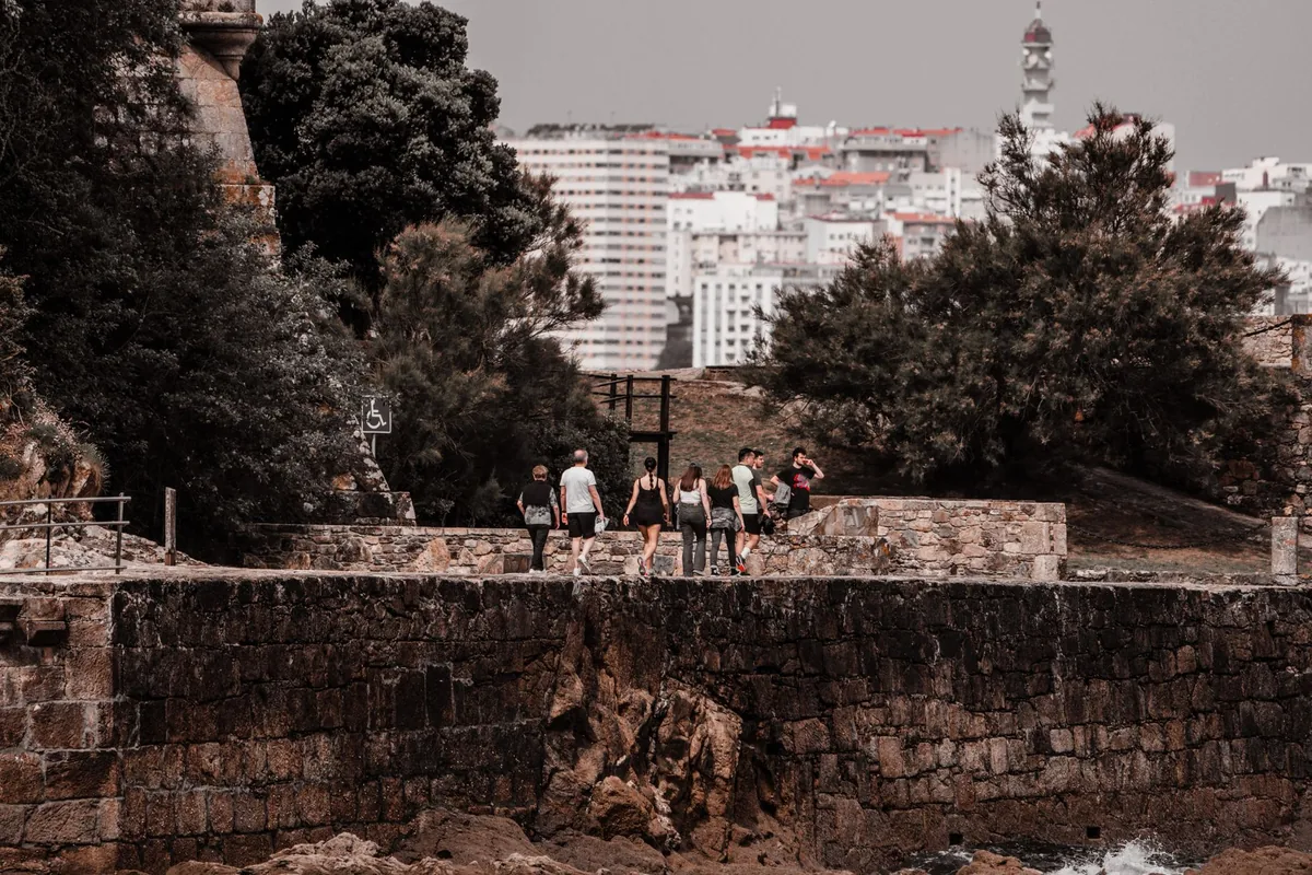 tourist group walking coastal path seaside town