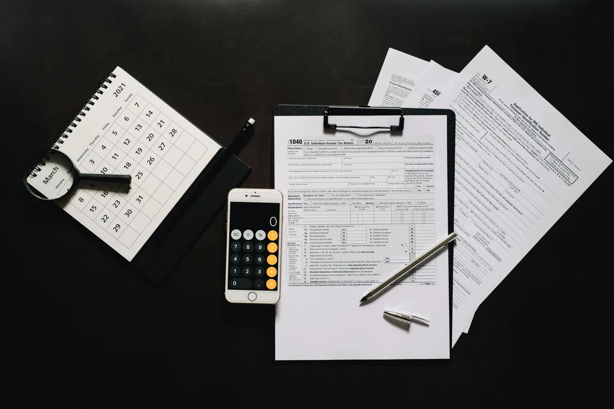 calculator tax forms paper ledger desk