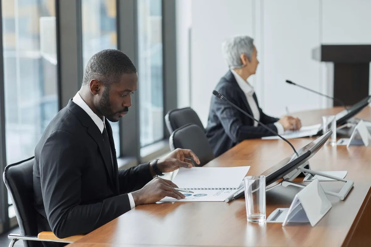 hotel executive analyzing digital dashboard in boardroom