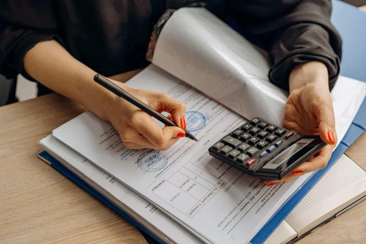 hotel manager reviewing accounting ledger spreadsheet