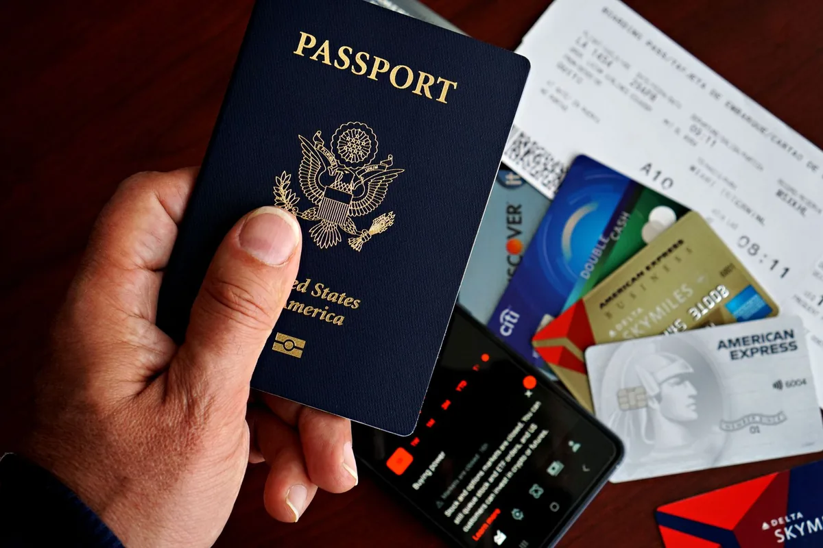 traveler holding passport and boarding pass