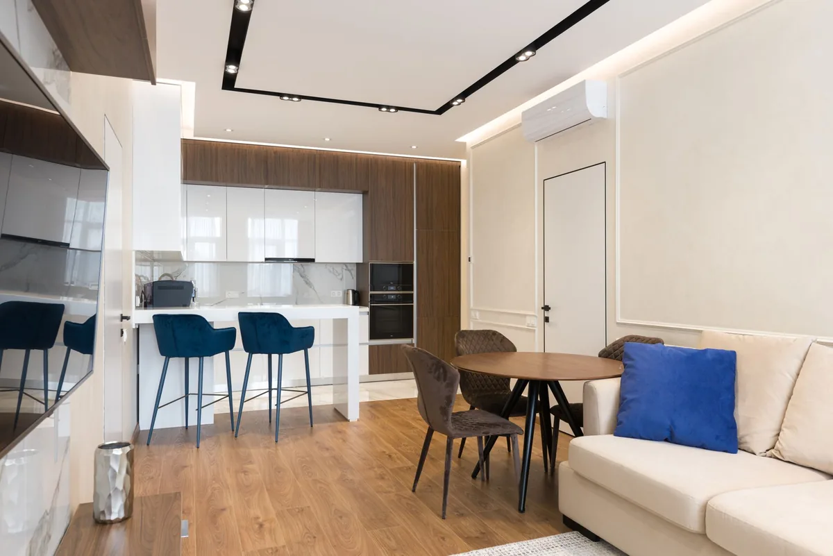 hotel guestroom with a small kitchen area and modern furnishings