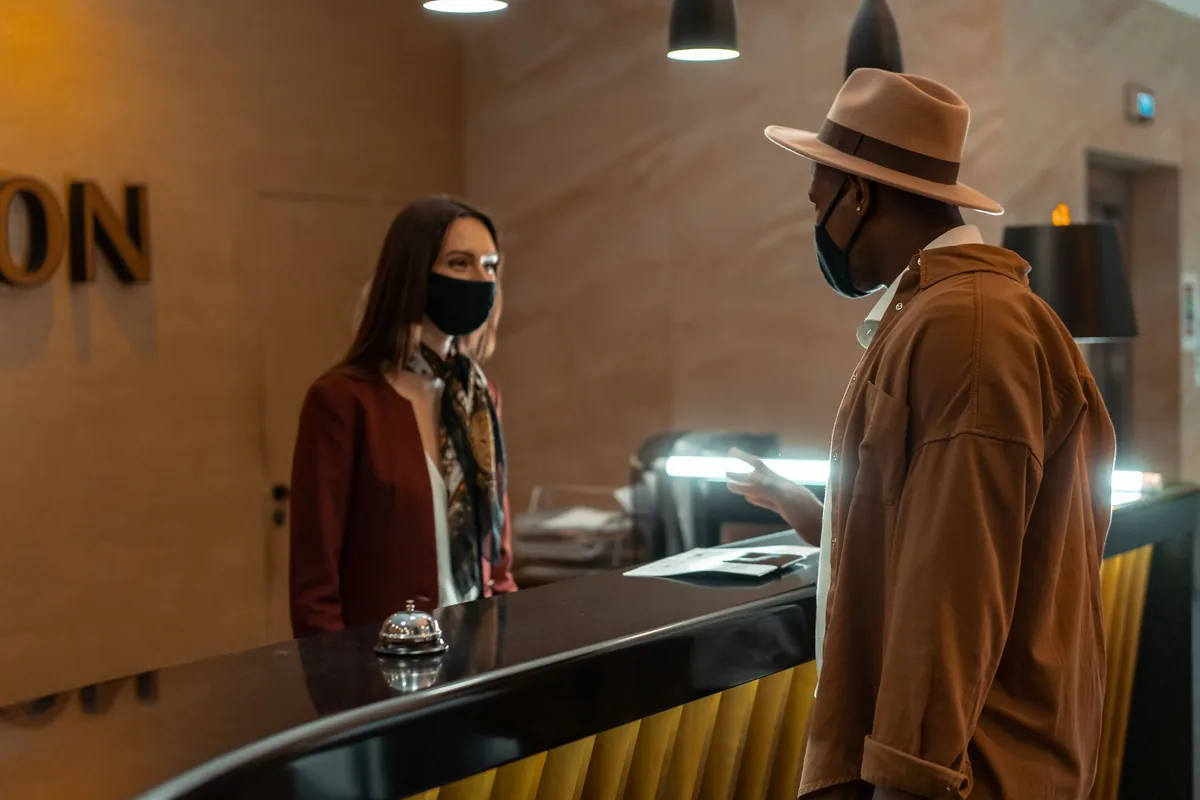 hotel front desk receptionist greeting guest