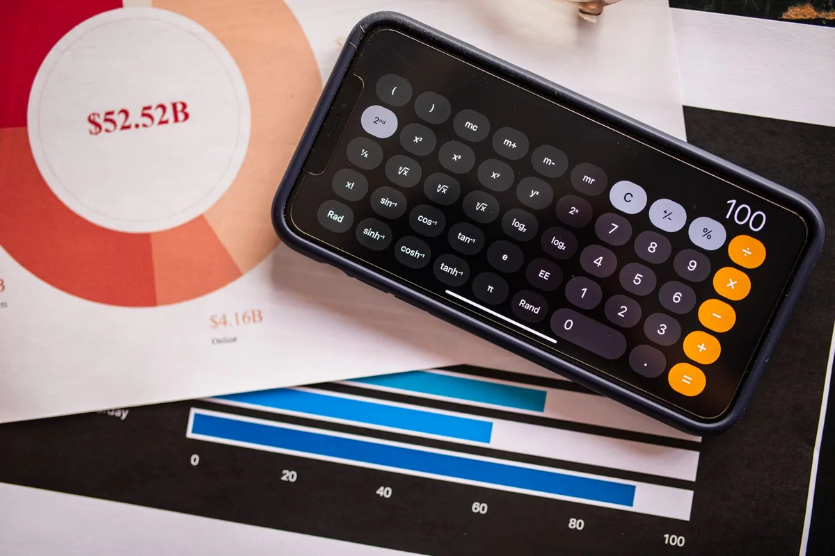 smartphone showing financial dashboard and revenue graphs